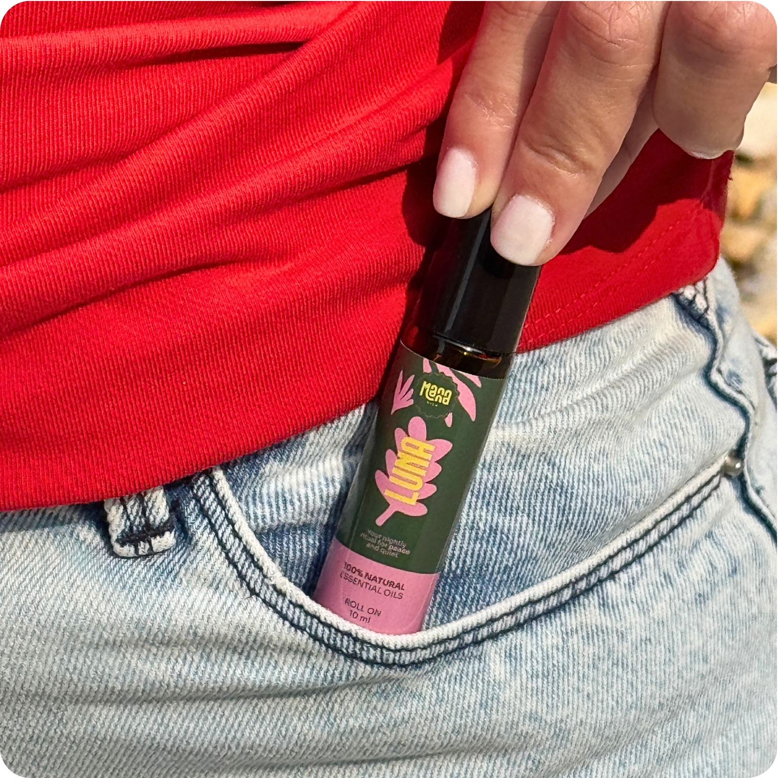 The LUNA aroma roller being slipped into a jeans pocket