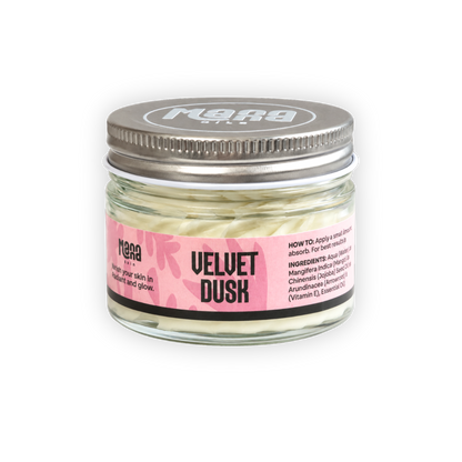 Manna Velvet Dusk body butter in a clear glass jar with a silver lid and a pink label